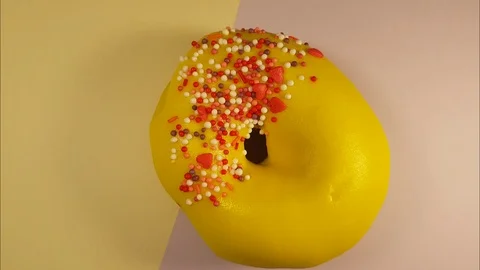 Donut on a yellow background turns Stock Footage 87905567