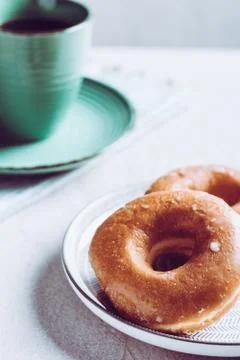 Donuts accompanied by a cup with coffee for breakfast. Stock Photos