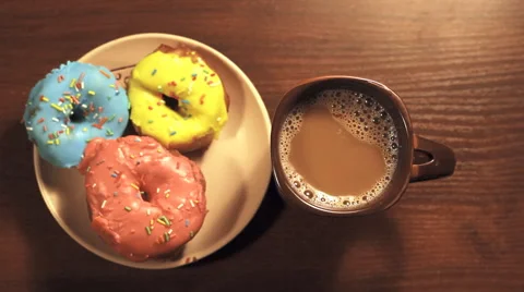 Donuts and coffee for breakfast Stock Footage 67732156