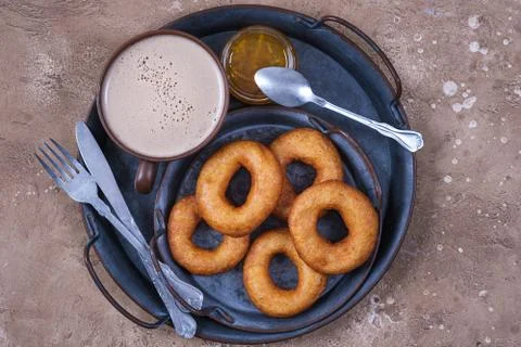 Donuts and jam with coffee cup on table Stock Photos