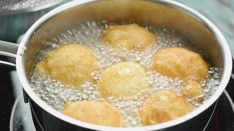 The donuts are frying in the pan. Stock Footage 209926528
