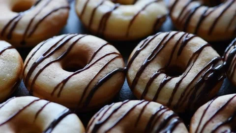 Donuts are poured with chocolate Stock Footage 177288066