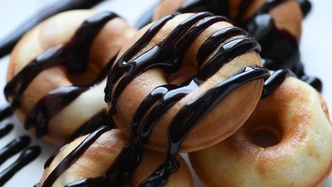 Donuts are poured with chocolate Stock Footage 179060684