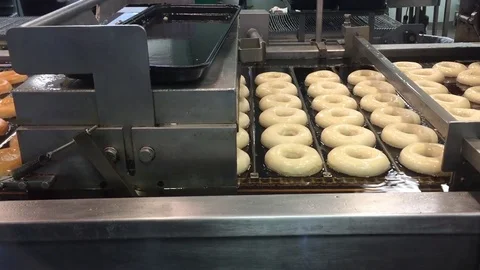 Donuts being fried in oil Stock Footage 72792219
