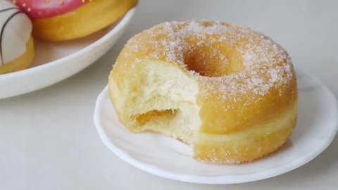 Donuts with bite mark on a white background. Stock Footage 312037948