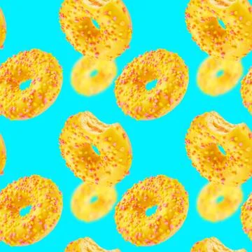 Donuts on blue background seamless texture or pattern. Stock Photos