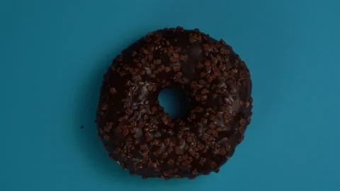 Donuts changing on a blue background 4K Stock Footage 220506550