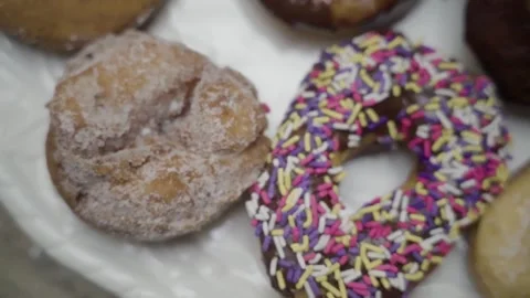 Donuts Cinnamon Sprinkles overhead close up slow motion pan left NJ Stock Footage 274844393