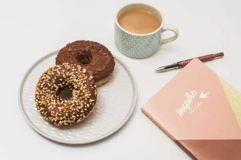 Donuts, coffee and notepad Stock Photos
