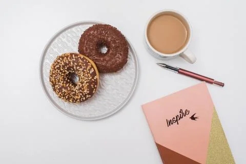 Donuts, coffee cup and notepad Stock Photos