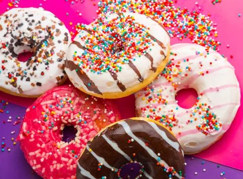 Donuts on color background. Stock Photos