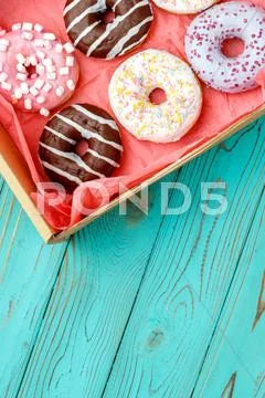 Donuts On Colorful Wooden Background