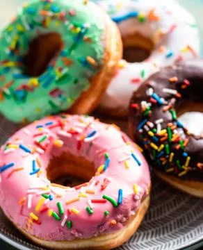 Donuts of different flavors for breakfast. Stock Photos