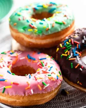 Donuts of different flavors for breakfast. Stock Photos