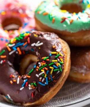 Donuts of different flavors for breakfast. Stock Photos