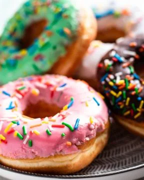 Donuts of different flavors for breakfast. Stock Photos