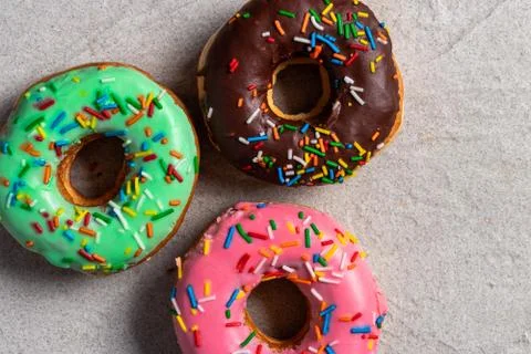 Donuts of different flavors for breakfast. Stock Photos