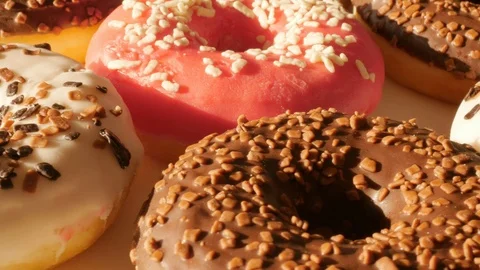 Donuts, doughnuts rotating, turning round, close Video stock 124254344