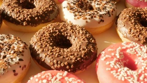 Donuts, doughnuts rotating, turning round Stock Footage 124254376