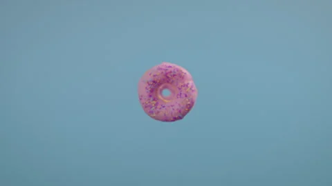 Donuts falling on a blue background Stock Footage 255722836