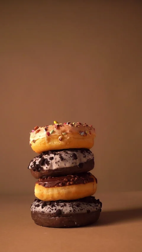 Donuts Falling Slow Motion Stack with Sprinkles and Chocolate Frosting Stock Footage 331232710