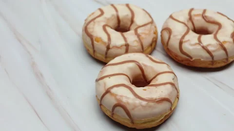 Donuts Glazed With White Icing With Brown Curls. Panning Dolly Slider Shot On A  스톡 동영상 150065159