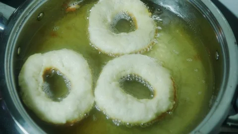 Donuts in oil close-up. 4k Video stock 98939622