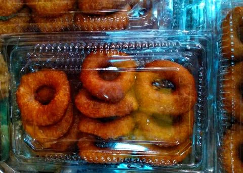 Donuts packed in plastic boxes Stock Photos