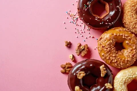 Donuts on pink background, from above Stock Photos