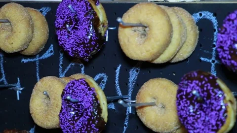 Donuts with Purple Spinkles Stock Footage 87346665