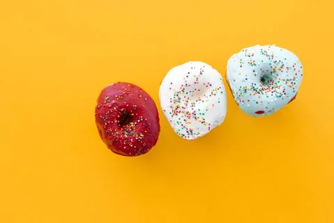 Donuts set isolated on a yellow background. Cute, colorful and glossy donut.. Stock Photos