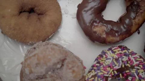 Donuts Sprinkles close up slow motion pan right Shamong New Jeresy 4k Stock Footage 274844404
