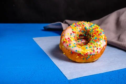 Donuts with sprinkles in the foreground Stock Photos