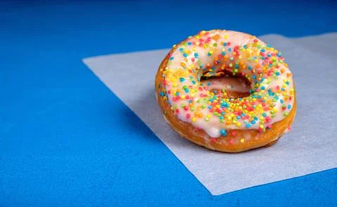 Donuts with sprinkles in the foreground Stock Photos