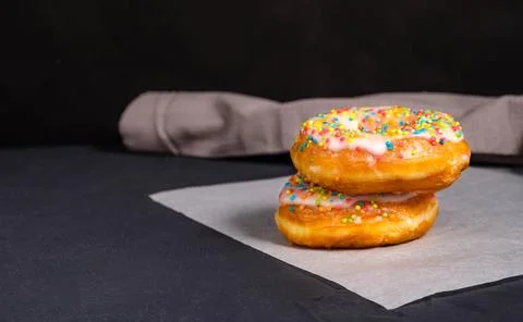 Donuts with sprinkles in the foreground Stock Photos