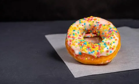 Donuts with sprinkles in the foreground Stock Photos
