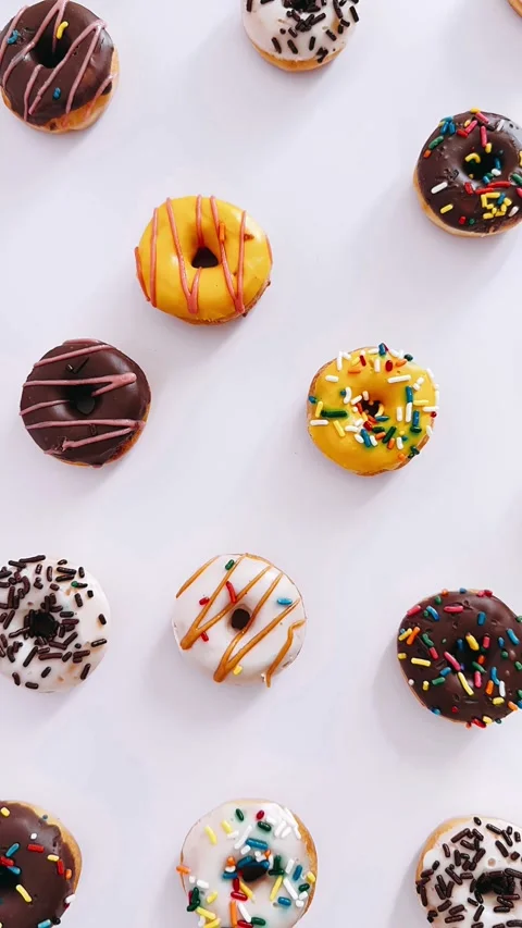 Donuts on white background, cute donut display, bite-sized donuts, Stock Footage 303998715