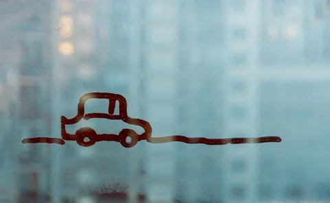 Doodle car driving down the road on blue foggy glass window Stock Photos