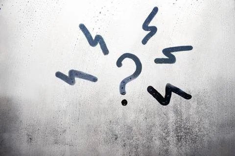 Doodle question mark with lightning in circle n foggy glass on city window Stock Photos