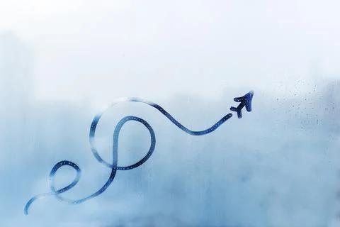 Doodle shape of plane and its trail on foggy glass window on blue background Stock Photos