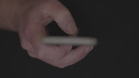 Doom scrolling. Finger of bored man scrolls page app on mobile phone Stock Footage 234145735