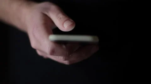 Doom scrolling. Single hand compulsive scrolling the mobile phone Stock Footage 234188667