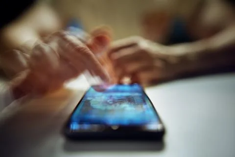 Doomscrolling. Close-Up of Man Scrolling Social Media Images on Smartphone. Stock Photos