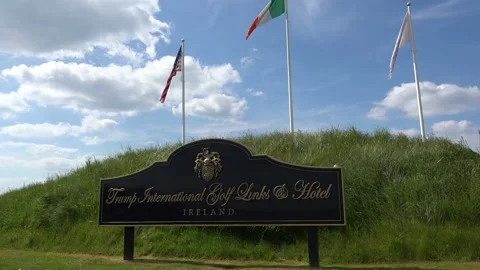 DOONBEG- 8.27.2023 -Low angle view of the American and Irish flags flying over Stock Footage 254114806