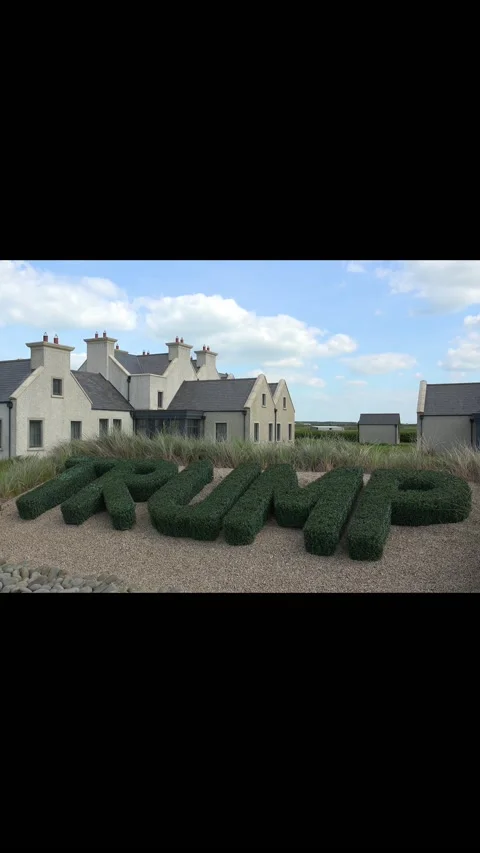DOONBEG- 8.27.2023 -Topiaries spelling out Trump's name stand in front of the Stock Footage 303986448