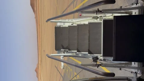 Door of an Airplane Closing Viewed From Inside in a Remote Dessert Landscape Video stock 345809422