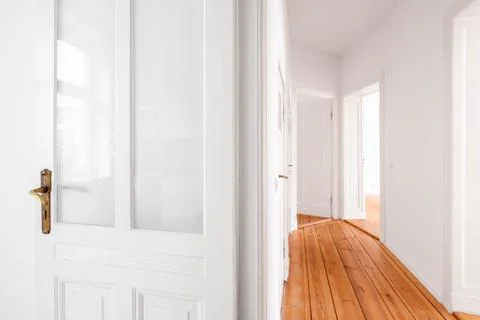 Door and corridor in empty flat in renovated old building Stock Photos