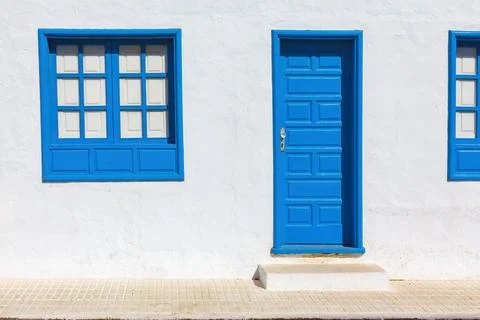 Door and windows painted in blue Stock Photos
