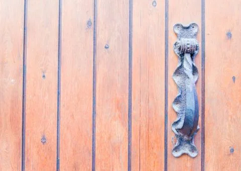 Door with brass knocker in the shape of a decor,  beautiful entrance Stock Photos