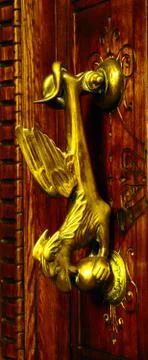 Door with brass knocker in the shape of a decor,  beautiful entrance Stock Photos